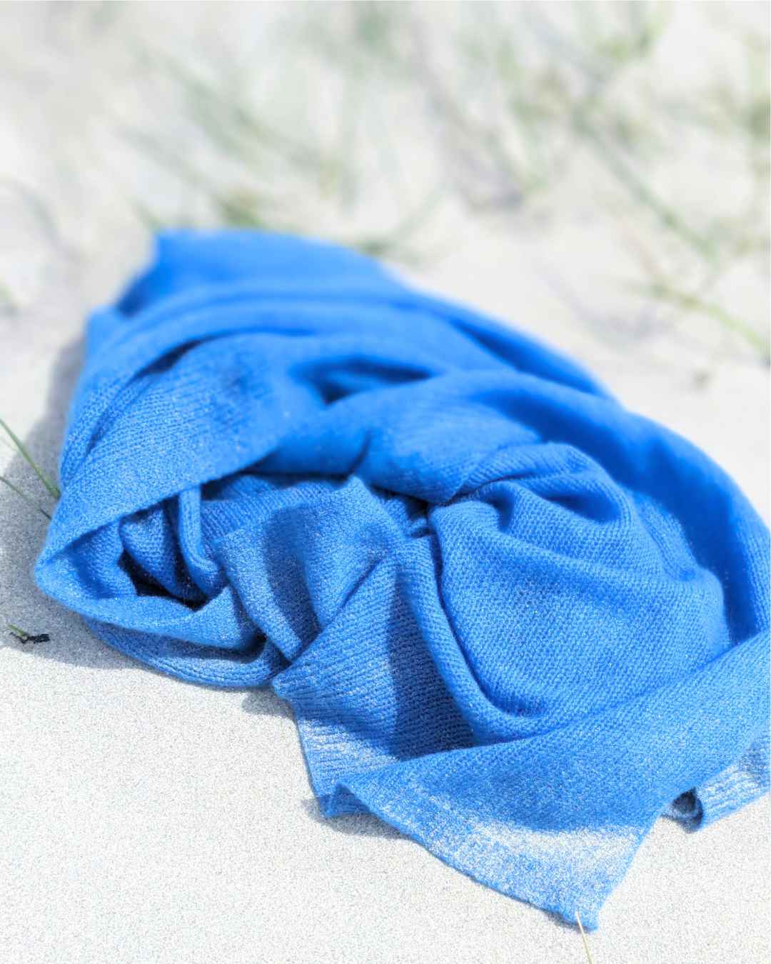 Close-up azure blue cashmere fiber texture showing featherlight organic sustainable fibres