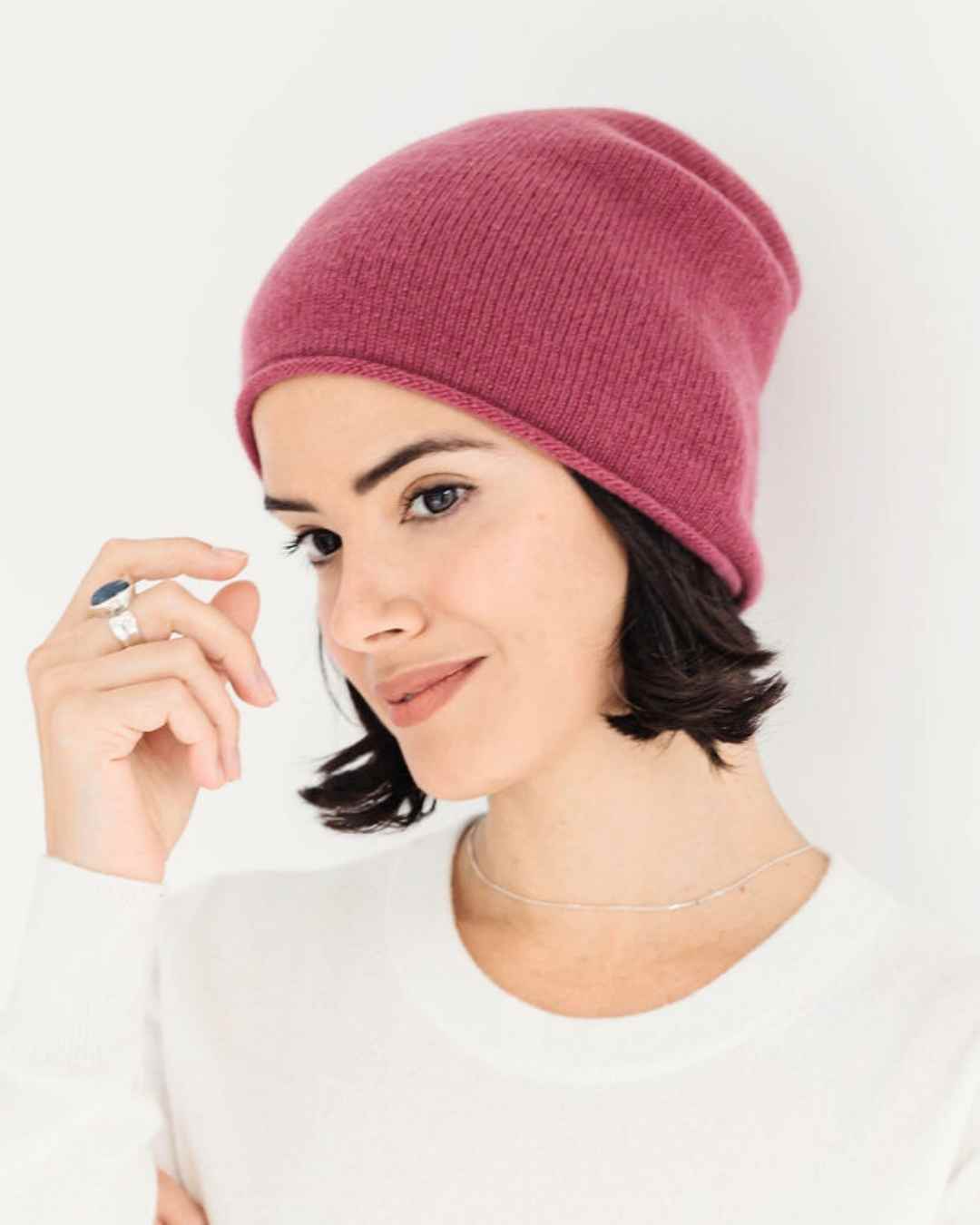 Front view of a soft, rosewood 100% cashmere slouchy beanie hat from the Winter 2026 collection.