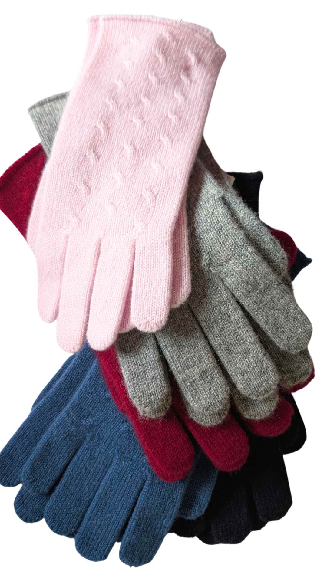 Stack of colorful gloves including pink, gray, blue, red, and black on a white background
