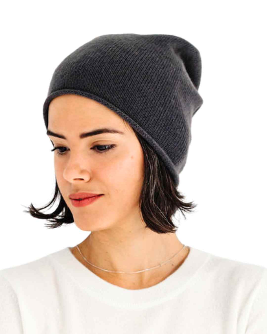 Woman wearing a graphite 100% cashmere slouchy beanie hat from the Winter organic collection.