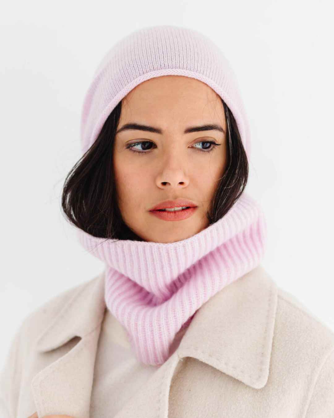 Front view of a soft, pale pink 100% cashmere rib snood from the Winter sustainable collection.