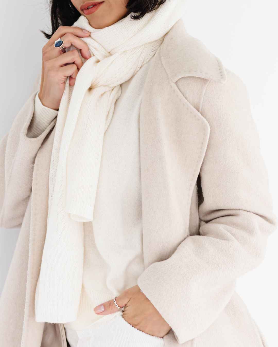 Woman wearing cream travel cashmere scarf styled as elegant wrap Ireland