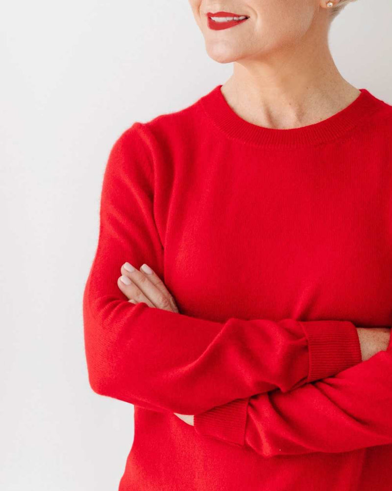 Woman wearing a red cashmere jumper